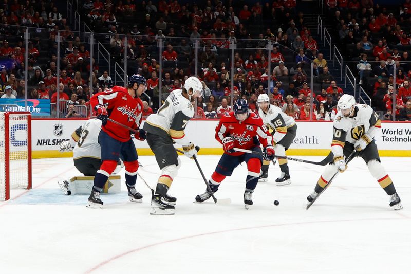 Oct 15, 2024; Washington, District of Columbia, USA; Washington Capitals left wing Andrew Mangiapane (88) and  Vegas Golden Knights center Nicolas Roy (10) battle for the puck in the third period at Capital One Arena. Mandatory Credit: Geoff Burke-Imagn Images