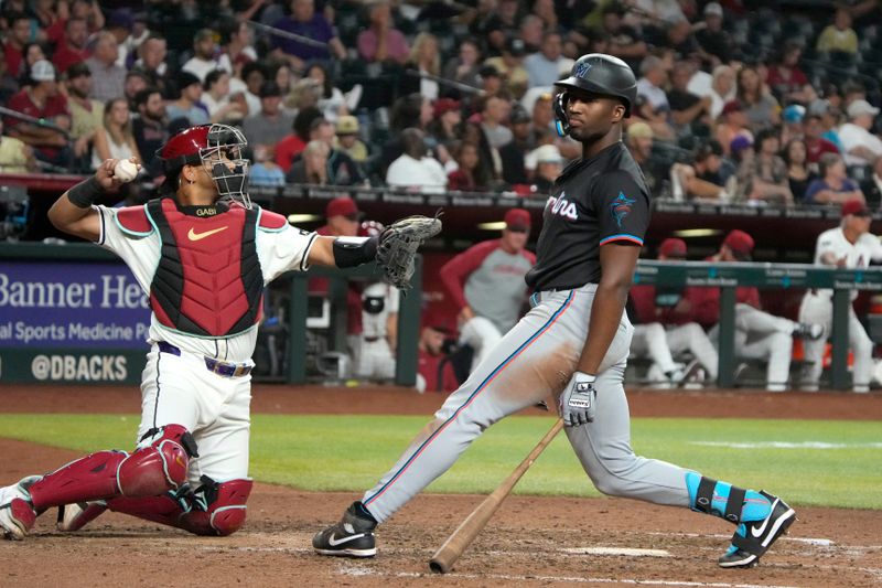 May 24, 2024; Phoenix, Arizona, USA; Miami Marlins outfielder Jesus Sanchez (12) reacts after missing a pitch against the Arizona Diamondbacks in the eighth inning at Chase Field. Mandatory Credit: Rick Scuteri-USA TODAY Sports