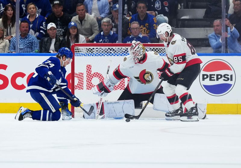 Apr 29, 2025; Toronto, Ontario, CAN; Toronto Maple Leafs center Bobby McMann (74) battles for the puck with Ottawa Senators defenseman Jake Sanderson (85) in the second period during game five of the first round of the 2025 Stanley Cup Playoffs at Scotiabank Arena. Mandatory Credit: Nick Turchiaro-Imagn Images