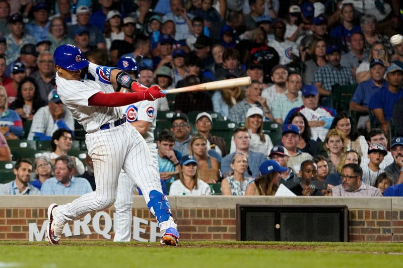 Jul 18, 2023; Chicago, Illinois, USA; Chicago Cubs catcher Miguel Amaya (6) hits a two-run single against the Washington Nationals during the seventh inning at Wrigley Field. Mandatory Credit: David Banks-USA TODAY Sports