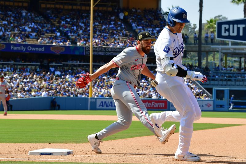 May 19, 2024; Los Angeles, California, USA; Los Angeles Dodgers designated hitter Shohei Ohtani (17) reaches first ahead of Cincinnati Reds pitcher Sam Moll (50) during the eighth inning at Dodger Stadium. Mandatory Credit: Gary A. Vasquez-USA TODAY Sports