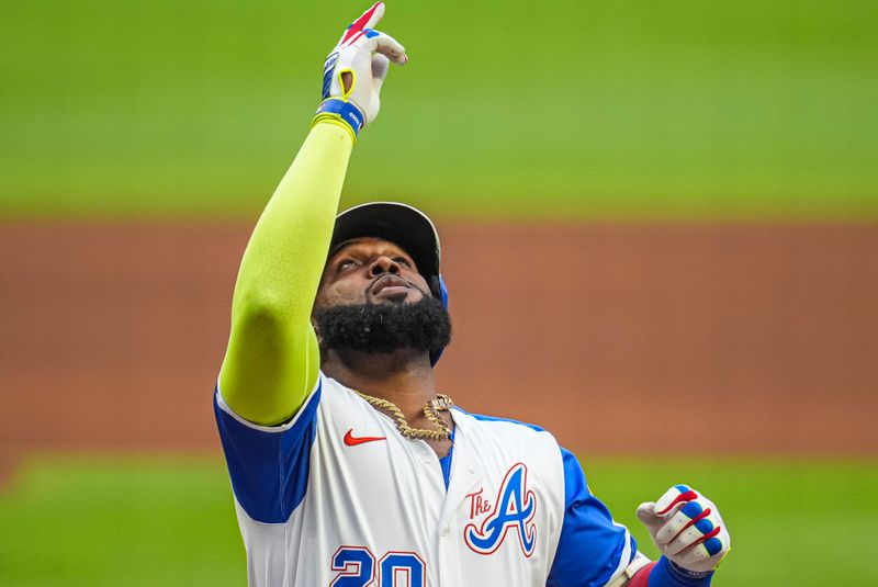 Jul 6, 2024; Cumberland, Georgia, USA; Atlanta Braves designated hitter Marcell Ozuna (20) reacts after hitting a home run against the Philadelphia Phillies during the first inning at Truist Park. Mandatory Credit: Dale Zanine-USA TODAY Sports