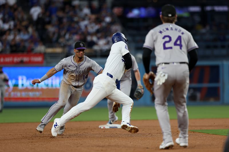 Jun 1, 2024; Los Angeles, California, USA;  Colorado Rockies shortstop Ezequiel Tovar (14) tags Los Angeles Dodgers designated hitter Shohei Ohtani (17) out on a pick off play during the third inning at Dodger Stadium. Mandatory Credit: Kiyoshi Mio-USA TODAY Sports