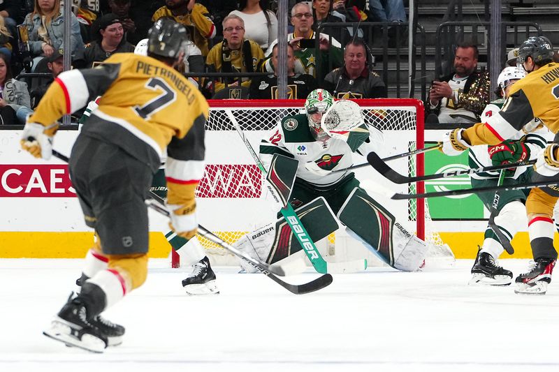 Feb 12, 2024; Las Vegas, Nevada, USA; Minnesota Wild goaltender Filip Gustavsson (32) looks to glove a shot from Vegas Golden Knights defenseman Alex Pietrangelo (7) during the second period at T-Mobile Arena. Mandatory Credit: Stephen R. Sylvanie-USA TODAY Sports