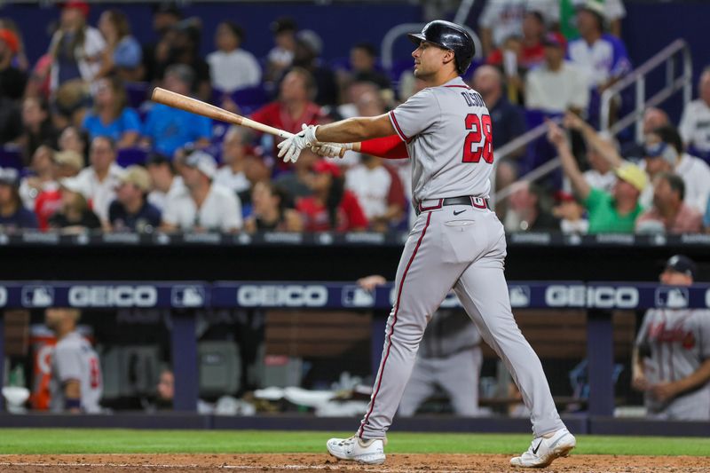 Sep 16, 2023; Miami, Florida, USA; Atlanta Braves first baseman Matt Olson (28) hits a home run against the Miami Marlins during the sixth inning at loanDepot Park. Mandatory Credit: Sam Navarro-USA TODAY Sports