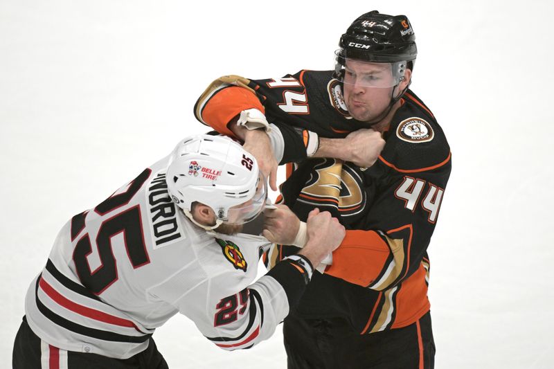 Mar 21, 2024; Anaheim, California, USA; Chicago Blackhawks defenseman Jarred Tinordi (25) and Anaheim Ducks left wing Ross Johnston (44) fight on the ice in the first period at Honda Center. Mandatory Credit: Jayne Kamin-Oncea-USA TODAY Sports