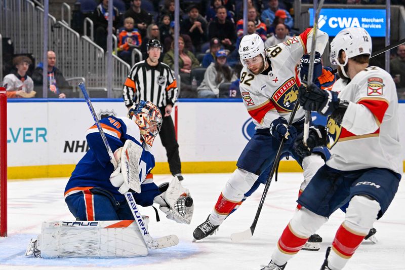 Jan 27, 2024; Elmont, New York, USA; New York Islanders goaltender Semyon Varlamov (40) makes a save as Florida Panthers center Kevin Stenlund (82) looks for the rebound during the third period at UBS Arena. Mandatory Credit: Dennis Schneidler-USA TODAY Sports