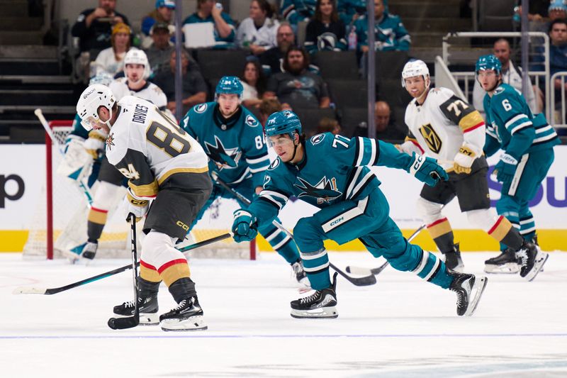 Sep 21, 2025; San Jose, California, USA; San Jose Sharks forward Michael Misa (77) extends for the puck against Vegas Golden Knights defenseman Jeremy Davies (84) during the second period at SAP Center at San Jose. Mandatory Credit: Robert Edwards-Imagn Images