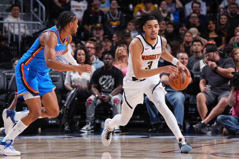 DENVER, CO - OCTOBER 15: Julian Strawther #3 of the Denver Nuggets dribbles the ball during the game against the Oklahoma City Thunder during a NBA preseason game on October 15, 2024 at Ball Arena in Denver, Colorado. NOTE TO USER: User expressly acknowledges and agrees that, by downloading and/or using this Photograph, user is consenting to the terms and conditions of the Getty Images License Agreement. Mandatory Copyright Notice: Copyright 2024 NBAE (Photo by Garrett Ellwood/NBAE via Getty Images)