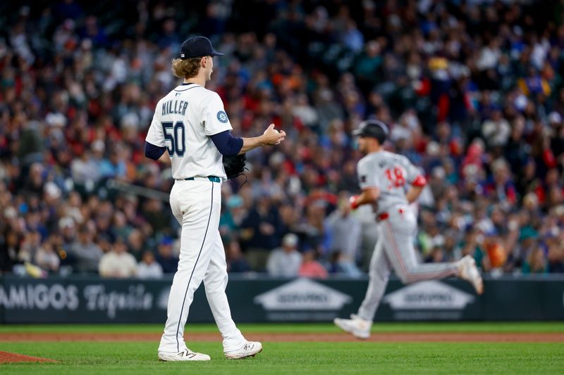 May 31, 2025; Seattle, Washington, USA; Seattle Mariners starting pitcher Bryce Miller (50) walks around the mound after surrendering a two-run home run to Minnesota Twins right fielder Matt Wallner (38, background) during the second inning at T-Mobile Park. Mandatory Credit: Joe Nicholson-Imagn Images