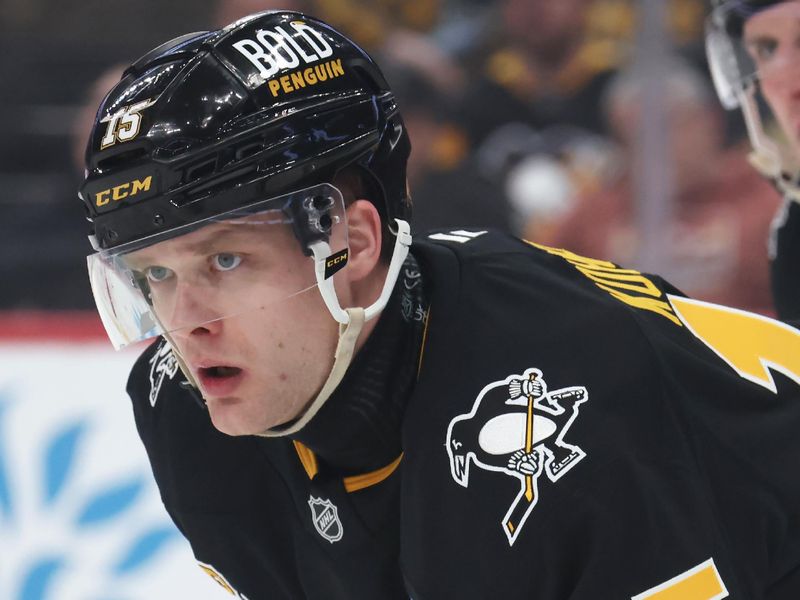 Mar 18, 2025; Pittsburgh, Pennsylvania, USA;  Pittsburgh Penguins left wing Joona Koppanen  (15) at the face-off circle against the New York Islanders during the second period at PPG Paints Arena. Mandatory Credit: Charles LeClaire-Imagn Images
