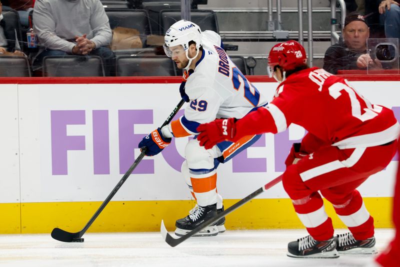 Nov 20, 2025; Detroit, Michigan, USA;  New York Islanders left wing Jonathan Drouin (29) skates with the puck defended by Detroit Red Wings defenseman Albert Johansson (20) in the first period at Little Caesars Arena. Mandatory Credit: Rick Osentoski-Imagn Images