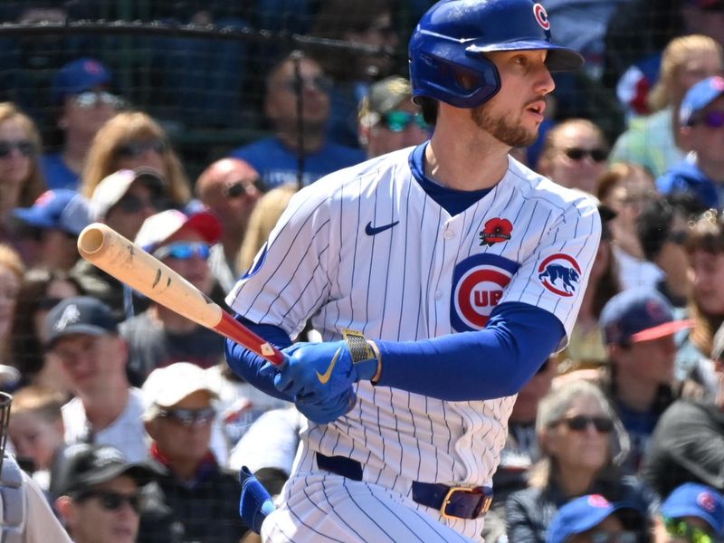 May 26, 2025; Chicago, Illinois, USA; Chicago Cubs right fielder Kyle Tucker (30) hits an RBI single during the fifth inning against the Colorado Rockies at Wrigley Field. Mandatory Credit: Patrick Gorski-Imagn Images