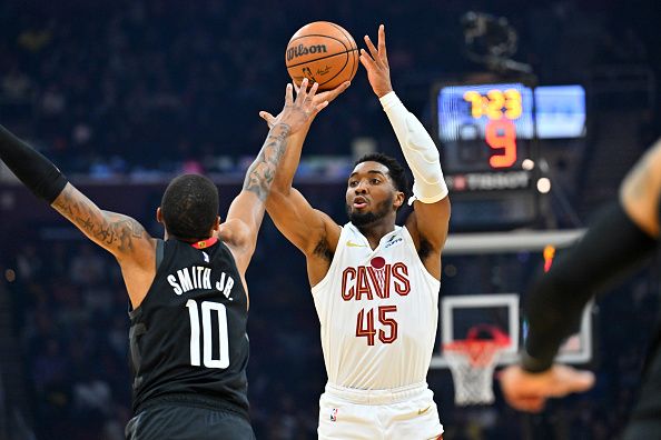 CLEVELAND, OHIO - DECEMBER 18: Donovan Mitchell #45 of the Cleveland Cavaliers shoots over Jabari Smith Jr. #10 of the Houston Rockets during the first quarter at Rocket Mortgage Fieldhouse on December 18, 2023 in Cleveland, Ohio. NOTE TO USER: User expressly acknowledges and agrees that, by downloading and or using this photograph, User is consenting to the terms and conditions of the Getty Images License Agreement. (Photo by Jason Miller/Getty Images)