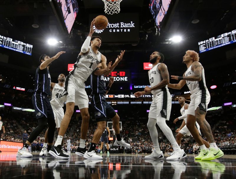 SAN ANTONIO, TX - OCTOBER 09:  Victor Wembanyama #1 of the San Antonio Spurs grabs a rebound against the Orlando Magic in the first half of a preseason game at Frost Bank Center on October 9, 2024 in San Antonio, Texas. NOTE TO USER: User expressly acknowledges and agrees that, by downloading and or using this photograph, User is consenting to terms and conditions of the Getty Images License Agreement. (Photo by Ronald Cortes/Getty Images)