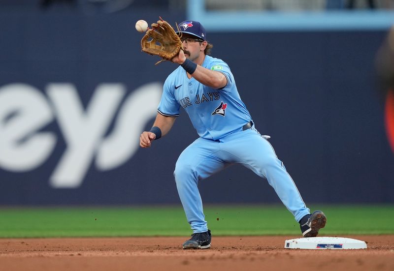 May 22, 2024; Toronto, Ontario, CAN; Toronto Blue Jays second baseman Davis Schneider (36) makes a catch at second base to get out Chicago White Sox first baseman Gavin Sheets (not pictured) to end the first inning at Rogers Centre. Mandatory Credit: John E. Sokolowski-USA TODAY Sports