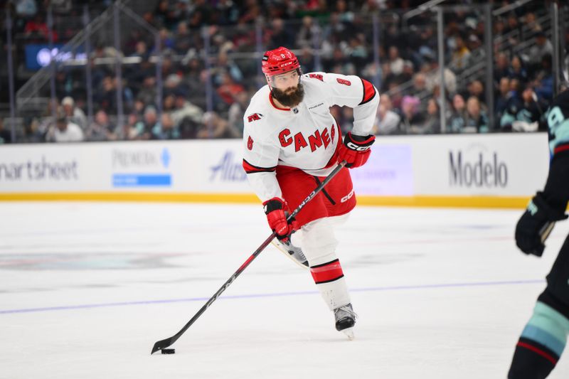 Oct 26, 2024; Seattle, Washington, USA; Carolina Hurricanes defenseman Brent Burns (8) passes the puck against the Seattle Kraken during the second period at Climate Pledge Arena. Mandatory Credit: Steven Bisig-Imagn Images