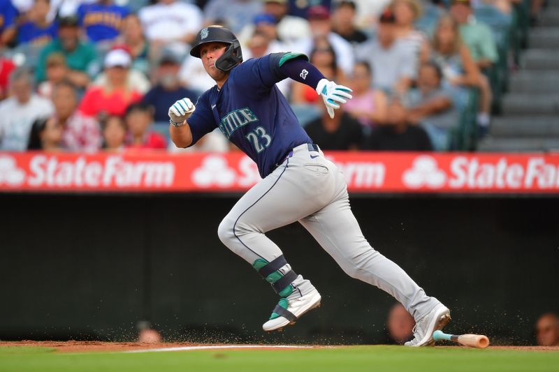 Jul 11, 2024; Anaheim, California, USA; Seattle Mariners first baseman Ty France (23) runs after hitting into a fielder choice against the Los Angeles Angels during the first inning at Angel Stadium. Mandatory Credit: Gary A. Vasquez-USA TODAY Sports