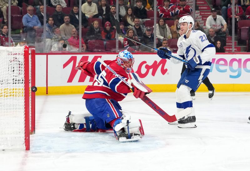 Dec 9, 2025; Montreal, Quebec, CAN; Tampa Bay Lightning forward Brayden Point (21) scores a goal against Montreal Canadiens goalie Jakub Dobes (75) during the first period at the Bell Centre. Mandatory Credit: Eric Bolte-Imagn Images