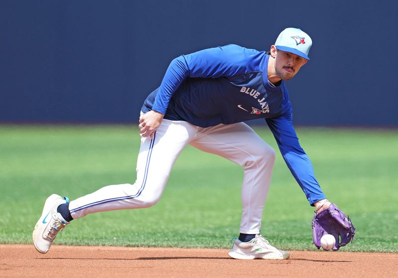 May 20, 2024; Toronto, Ontario, CAN; Toronto Blue Jays second base Cavan Biggio (8) fields balls during batting practice before a game against the Chicago White Sox at Rogers Centre. Mandatory Credit: Nick Turchiaro-USA TODAY Sports