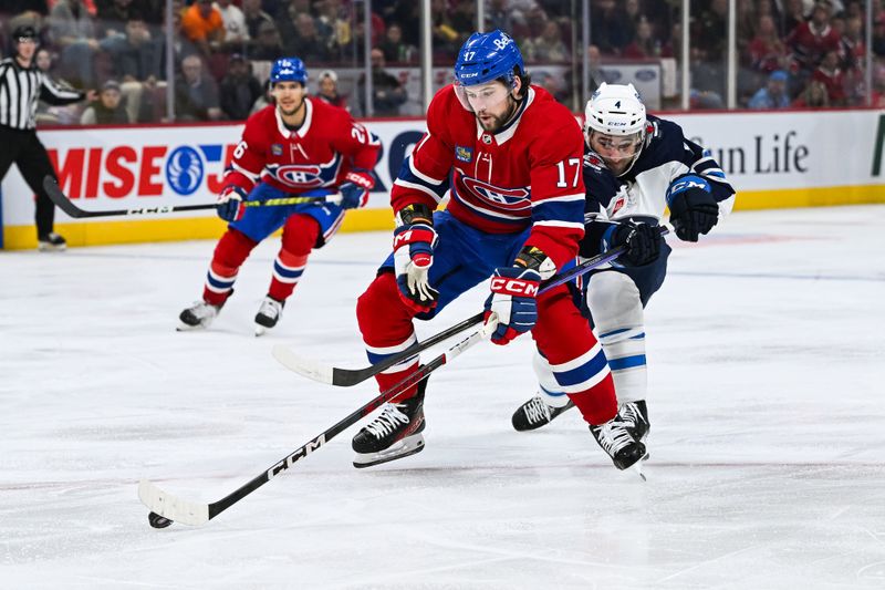 Oct 28, 2023; Montreal, Quebec, CAN; Winnipeg Jets defenseman Neal Pionk (4) defends against Montreal Canadiens right wing Josh Anderson (17) during the second period at Bell Centre. Mandatory Credit: David Kirouac-USA TODAY Sports