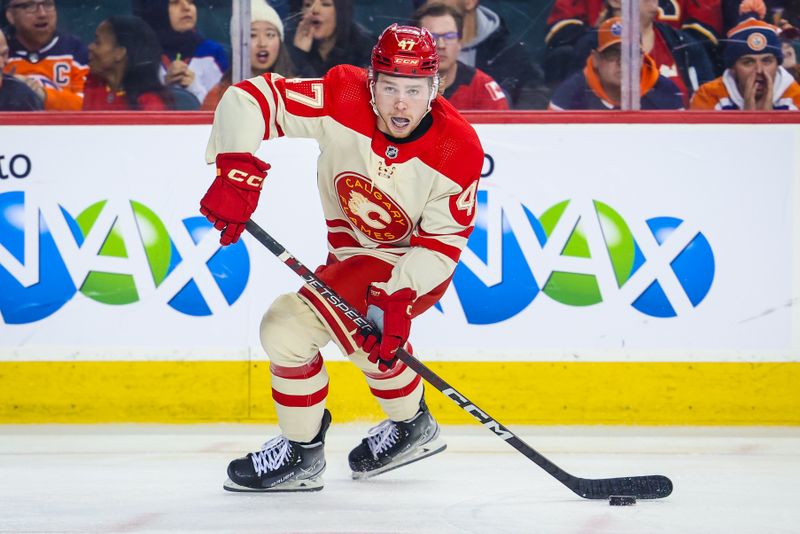 Jan 20, 2024; Calgary, Alberta, CAN; Calgary Flames center Connor Zary (47) skates with the puck against the Edmonton Oilers during the third period at Scotiabank Saddledome. Mandatory Credit: Sergei Belski-USA TODAY Sports