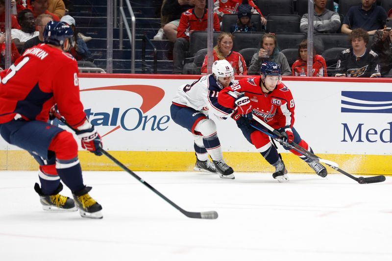 Sep 27, 2024; Washington, District of Columbia, USA; Washington Capitals left wing Andrew Mangiapane (88) passes the puck to Capitals left wing Alex Ovechkin (8) prior to a goal as Columbus Blue Jackets center Dylan Gambrell (18) defends in the first period at Capital One Arena. Mandatory Credit: Geoff Burke-Imagn Images