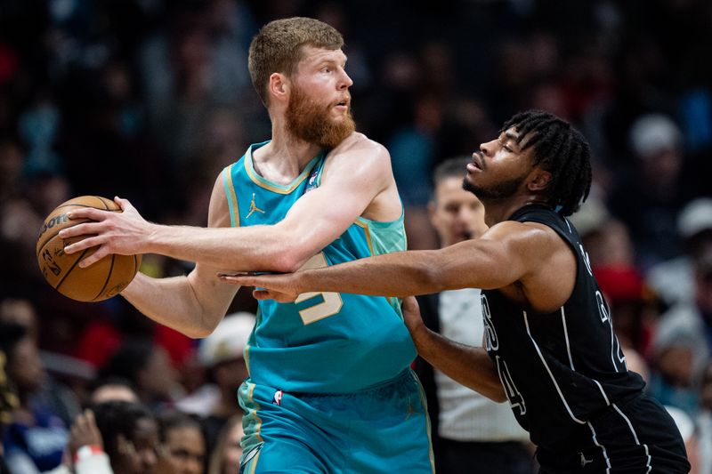 CHARLOTTE, NORTH CAROLINA - MARCH 09: Cam Thomas #24 of the Brooklyn Nets tries to knock the ball away from Davis Bertans #9 of the Charlotte Hornets in the second quarter during their game at Spectrum Center on March 09, 2024 in Charlotte, North Carolina. NOTE TO USER: User expressly acknowledges and agrees that, by downloading and or using this photograph, User is consenting to the terms and conditions of the Getty Images License Agreement. (Photo by Jacob Kupferman/Getty Images)