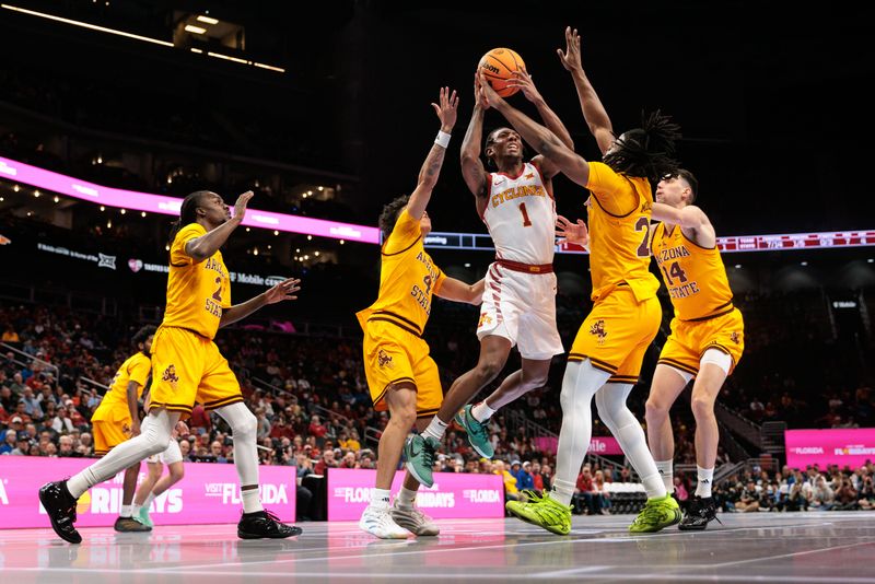 Mar 11, 2026; Kansas City, MO, USA; Iowa State Cyclones guard Jamarion Batemon (1) shoots the ball between Arizona State Sun Devils guard Bryce Ford (4) and Arizona State Sun Devils guard Anthony Johnson (2) during the first half at T-Mobile Center. Mandatory Credit: William Purnell-Imagn Images