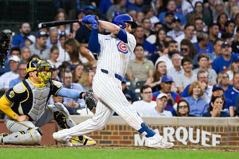 Jul 22, 2024; Chicago, Illinois, USA;  Chicago Cubs first base Michael Busch (29) hits an RBI single against the Milwaukee Brewers during the third inning at Wrigley Field. Mandatory Credit: Matt Marton-USA TODAY Sports