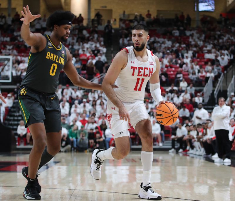 Jan 17, 2023; Lubbock, Texas, USA;  Texas Tech Red Raiders forward Fardaws Aimaq (11) dribbles the ball around Baylor Bears forward Flo Thumb (0) in the first half at United Supermarkets Arena. Mandatory Credit: Michael C. Johnson-USA TODAY Sports