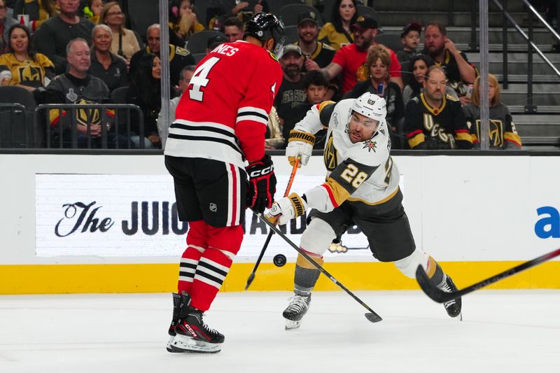 Oct 27, 2023; Las Vegas, Nevada, USA; Chicago Blackhawks defenseman Seth Jones (4) blocks a shot by Vegas Golden Knights left wing William Carrier (28) during the first period at T-Mobile Arena. Mandatory Credit: Stephen R. Sylvanie-USA TODAY Sports