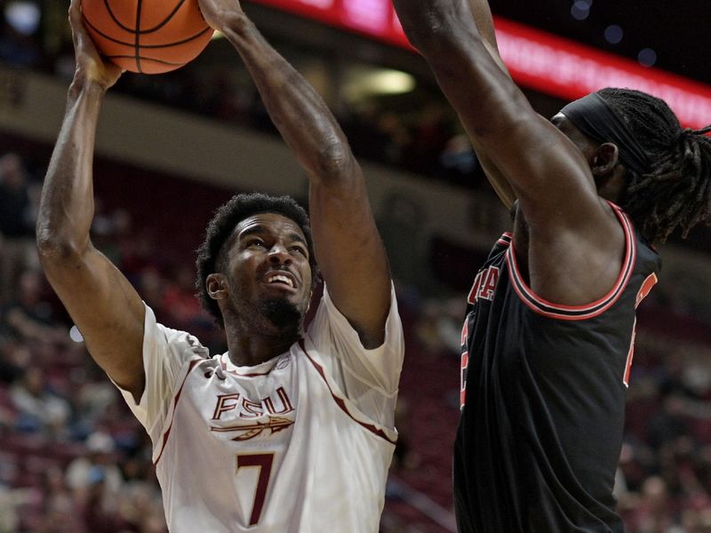 Dec 2, 2025; Tallahassee, Florida, USA; Florida State Seminoles forward Chauncey Wiggins (7) shoots the ball against Georgia Bulldogs Somtochukwu Cyril (2) during the first half at Donald L. Tucker Center. Mandatory Credit: Melina Myers-Imagn Images