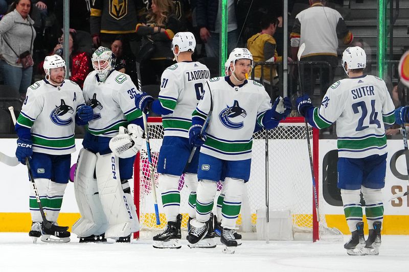 Mar 7, 2024; Las Vegas, Nevada, USA; Vancouver Canucks players celebrate after defeating the Vegas Golden Knights 3-1 at T-Mobile Arena. Mandatory Credit: Stephen R. Sylvanie-USA TODAY Sports