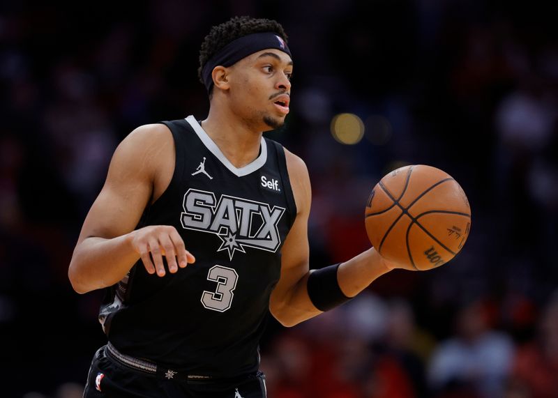 HOUSTON, TEXAS - DECEMBER 11: Keldon Johnson #3 of the San Antonio Spurs controls the ball against the Houston Rockets during the first half at Toyota Center on December 11, 2023 in Houston, Texas. NOTE TO USER: User expressly acknowledges and agrees that, by downloading and or using this photograph, User is consenting to the terms and conditions of the Getty Images License Agreement.? (Photo by Carmen Mandato/Getty Images)