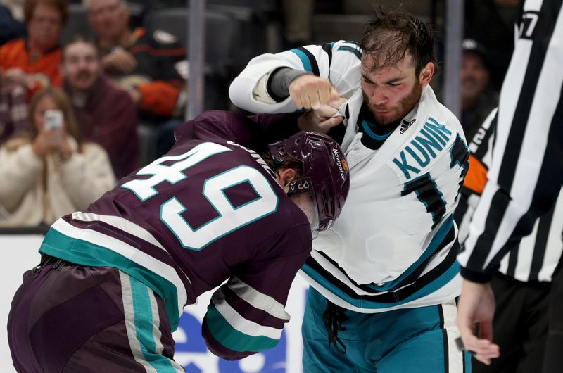 Nov 12, 2023; Anaheim, California, USA; San Jose Sharks center Luke Kunin (11) and Anaheim Ducks left wing Max Jones (49) fight during the second period at Honda Center. Mandatory Credit: Jason Parkhurst-USA TODAY Sports