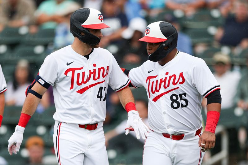 Mar 6, 2024; Fort Myers, Florida, USA;  Minnesota Twins catcher Jair Camargo (85) congratulates second baseman Edouard Julien (47) after hitting a three run home run against the Boston Red Sox in the third inning at Hammond Stadium. Mandatory Credit: Nathan Ray Seebeck-USA TODAY Sports