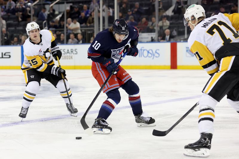 Dec 6, 2024; New York, New York, USA; New York Rangers left wing Artemi Panarin (10) plays the puck against Pittsburgh Penguins centers Noel Acciari (55) and Evgeni Malkin (71) during the third period at Madison Square Garden. Mandatory Credit: Brad Penner-Imagn Images