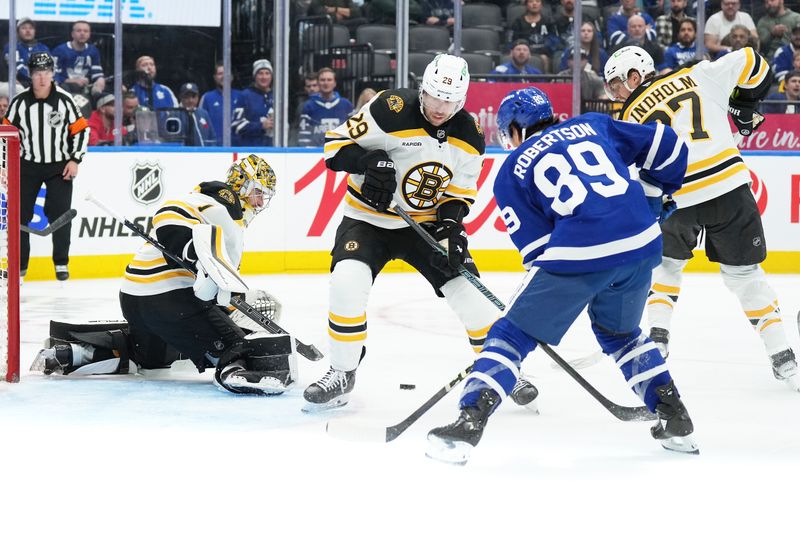 Nov 5, 2024; Toronto, Ontario, CAN; Toronto Maple Leafs left wing Nicholas Robertson (89) battles for the puck with Boston Bruins defenseman Parker Wotherspoon (29) during  the third period at Scotiabank Arena. Mandatory Credit: Nick Turchiaro-Imagn Imagess