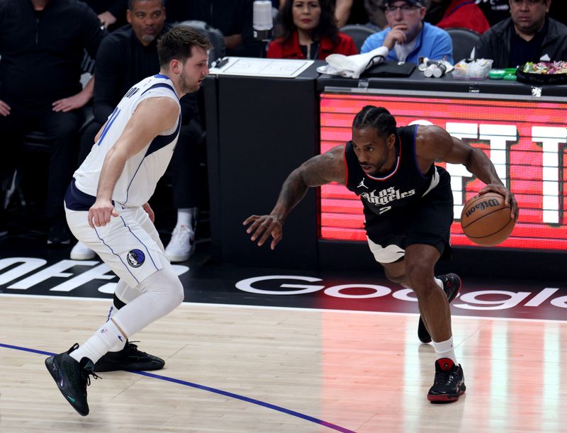 LOS ANGELES, CALIFORNIA - APRIL 23: Kawhi Leonard #2 of the LA Clippers drives to the basket on Luka Doncic #77 of the Dallas Mavericks during the first half at Crypto.com Arena on April 23, 2024 in Los Angeles, California. User is consenting to the terms and conditions of the Getty Images License Agreement. (Photo by Harry How/Getty Images)