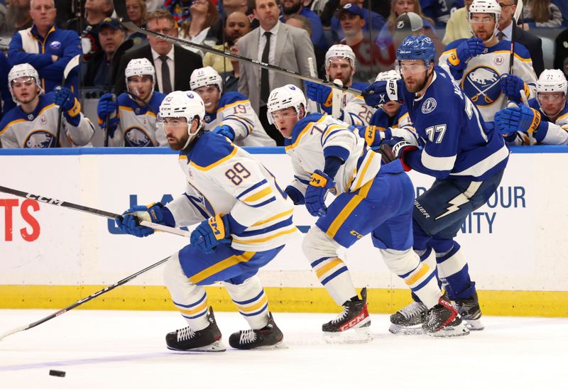 Apr 15, 2024; Tampa, Florida, USA;  Tampa Bay Lightning defenseman Victor Hedman (77), right wing JJ Peterka (77) and right wing Alex Tuch (89) skate after the puck during the third period at Amalie Arena. Mandatory Credit: Kim Klement Neitzel-USA TODAY Sports