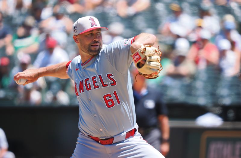 Jul 4, 2024; Oakland, California, USA; Los Angeles Angels relief pitcher Hunter Strickland (61) pitches the ball against the Oakland Athletics during the third inning at Oakland-Alameda County Coliseum. Mandatory Credit: Kelley L Cox-USA TODAY Sports