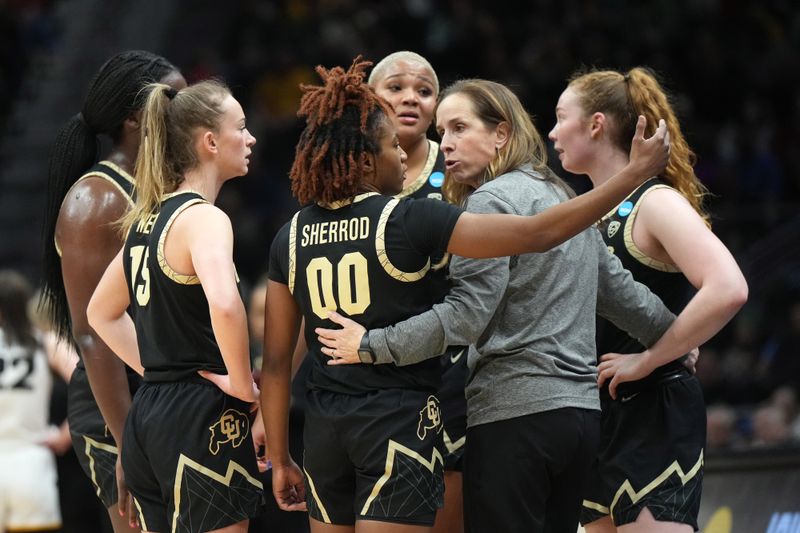 Mar 24, 2023; Seattle, WA, USA; Colorado Buffaloes coach JR Payne huddles with guard Jaylyn Sherrod (00) against the Iowa Hawkeyes in the second half at Climate Pledge Arena. Mandatory Credit: Kirby Lee-USA TODAY Sports