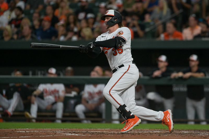 Aug 22, 2023; Baltimore, Maryland, USA;  Baltimore Orioles catcher Adley Rutschman (35) hits a third inning double against the Toronto Blue Jays at Oriole Park at Camden Yards. Mandatory Credit: Tommy Gilligan-USA TODAY Sports