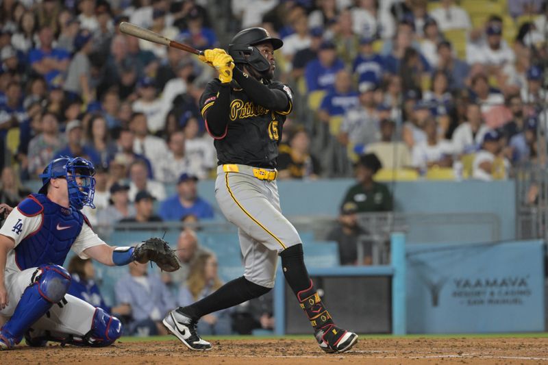 Aug 9, 2024; Los Angeles, California, USA; Pittsburgh Pirates shortstop Oneil Cruz (15) hits a solo home run in the fourth inning against the Pittsburgh Pirates at Dodger Stadium. Mandatory Credit: Jayne Kamin-Oncea-USA TODAY Sports