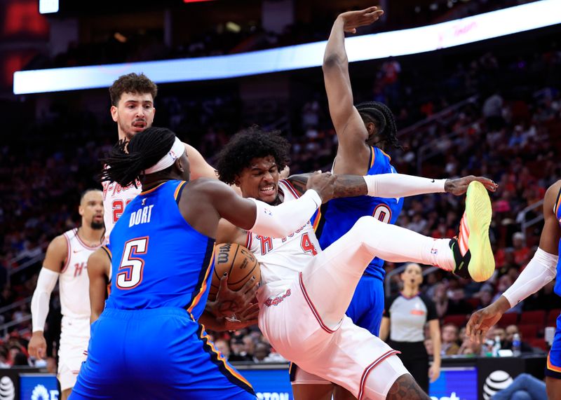 HOUSTON, TEXAS - FEBRUARY 25: Jalen Green #4 of the Houston Rockets collides with Luguentz Dort #5 of the Oklahoma City Thunder during the second  half at Toyota Center on February 25, 2024 in Houston, Texas. NOTE TO USER: User expressly acknowledges and agrees that, by downloading and or using this photograph, User is consenting to the terms and conditions of the Getty Images License Agreement. (Photo by Carmen Mandato/Getty Images)