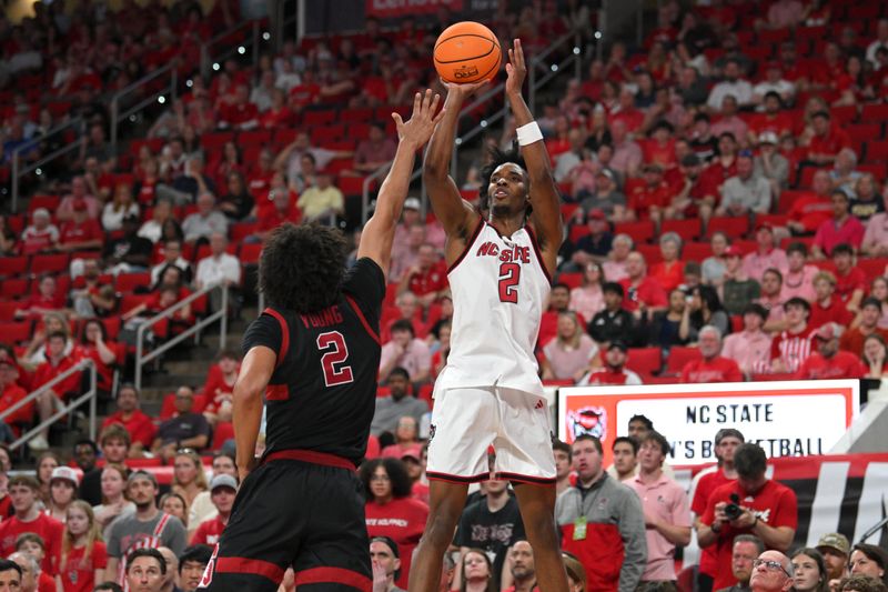 Mar 7, 2026; Raleigh, North Carolina, USA;  NC State Wolfpack guard Paul McNeil Jr. (2) shoots the ball against Stanford Cardinal guard Ebuka Okorie (1) during the first half at Lenovo Center. Mandatory Credit: Zachary Taft-Imagn Images