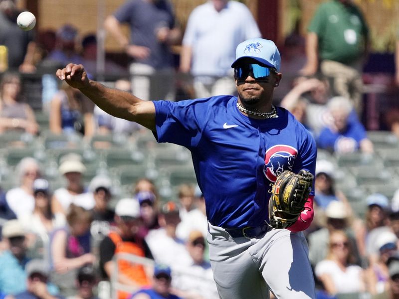 Mar 21, 2024; Salt River Pima-Maricopa, Arizona, USA; Chicago Cubs third baseman Christopher Morel (5) makes the off balance throw against the Colorado Rockies in the first inning at Salt River Fields at Talking Stick. Mandatory Credit: Rick Scuteri-USA TODAY Sports