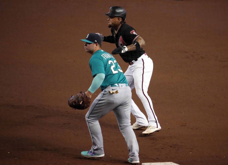 Jul 29, 2023; Phoenix, Arizona, USA; Arizona Diamondbacks second baseman Ketel Marte (4) leads off first base as Seattle Mariners first baseman Ty France (23) covers the bag during fourth the inning at Chase Field. Mandatory Credit: Joe Camporeale-USA TODAY Sports