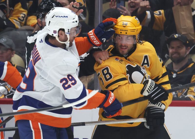 Oct 9, 2025; Pittsburgh, Pennsylvania, USA;  New York Islanders left wing Jonathan Drouin (29) and Pittsburgh Penguins defenseman Kris Letang (58) fight during the second period at PPG Paints Arena. Mandatory Credit: Charles LeClaire-Imagn Images